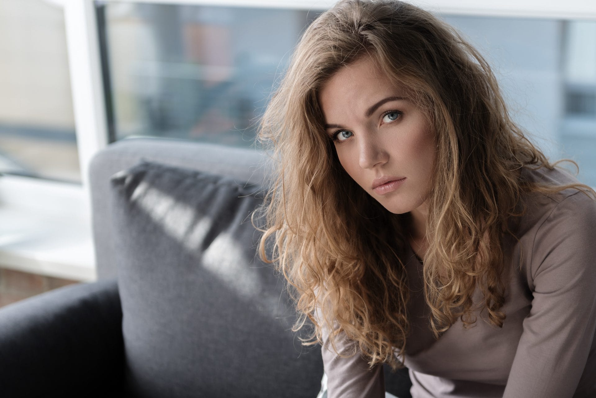 Distressed woman sitting on couch